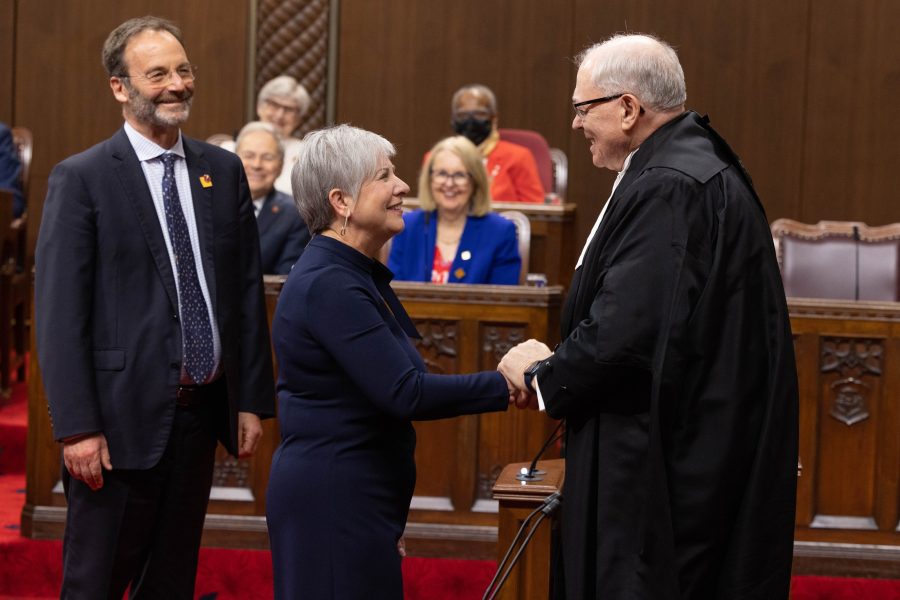 Senator Iris Petten shakes hands with Speaker George Furey on May 9, 2023 as Senator Marc Gold (left) watches.